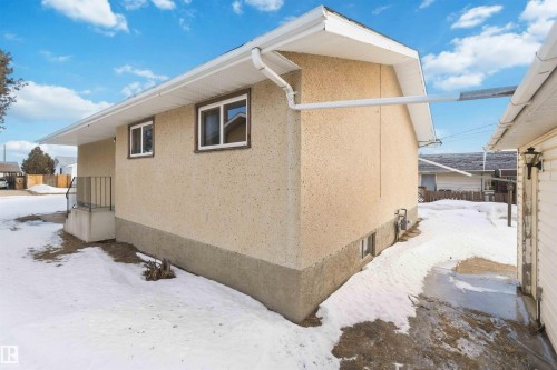 View of snowy exterior with stucco siding - 4615 49 Avenue, Redwater, AB - Outdoor With Exterior
