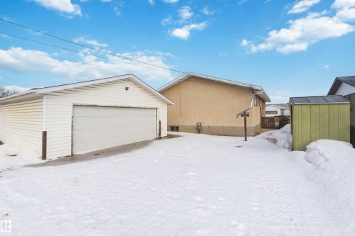 Snow covered garage with a detached garage and a storage shed - 4615 49 Avenue, Redwater, AB - Outdoor With Exterior
