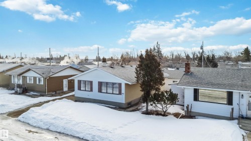 View of front of home with a residential view, a shingled roof, and a chimney - 4615 49 Avenue, Redwater, AB - Outdoor
