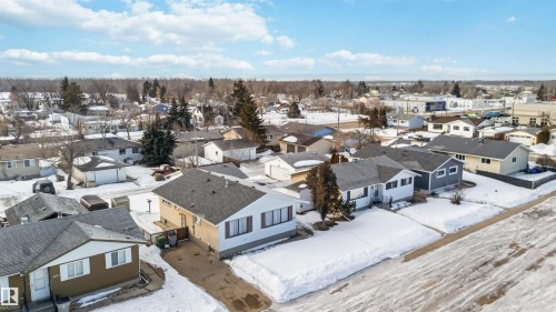Snowy aerial view with a residential view - 4615 49 Avenue, Redwater, AB - Outdoor With View