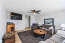 Living room featuring light wood-type flooring, ceiling fan, and a textured ceiling - 4615 49 Avenue, Redwater, AB  - Indoor Photo Showing Living Room 