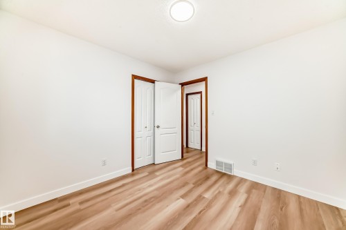Unfurnished bedroom featuring wood finished floors and a closet - 14063 128 Street, Edmonton, AB - Indoor Photo Showing Other Room