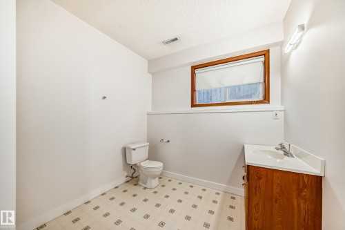 Bathroom with light floors, vanity, and a textured ceiling - 14063 128 Street, Edmonton, AB - Indoor Photo Showing Bathroom