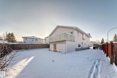 Snow covered rear of property featuring a fenced backyard - 14063 128 Street, Edmonton, AB - Outdoor With Exterior