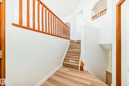 Staircase with wood finished floors and baseboards - 14063 128 Street, Edmonton, AB - Indoor Photo Showing Other Room