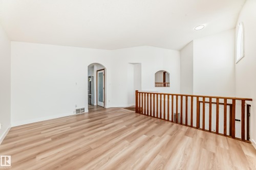 Spare room with arched walkways, light wood-type flooring, and recessed lighting - 14063 128 Street, Edmonton, AB - Indoor Photo Showing Other Room