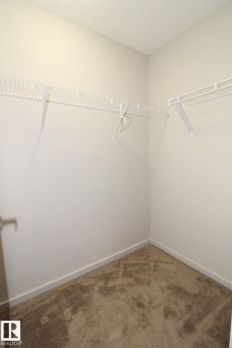 Walk in closet featuring carpet floors - 430 5515 7 Avenue, Edmonton, AB - Indoor With Storage