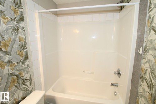 Bathroom with shower / tub combo with curtain - 430 5515 7 Avenue, Edmonton, AB - Indoor Photo Showing Bathroom