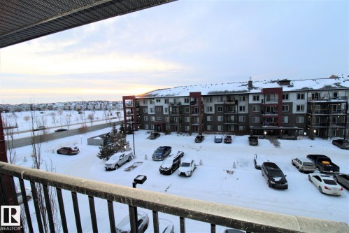 View of snow covered back of property - 430 5515 7 Avenue, Edmonton, AB - Outdoor With Balcony