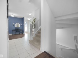 Staircase featuring tile patterned floors and baseboards - 