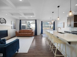 Living area with coffered ceiling, recessed lighting, dark wood-style floors, and a fireplace - 