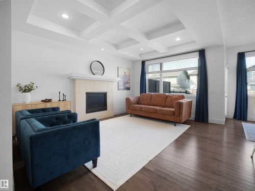 Living area with coffered ceiling, hardwood / wood-style flooring, recessed lighting, and a fireplace - 3387 Parker Loop, Edmonton, AB - Indoor Photo Showing Living Room With Fireplace
