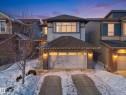 View of front of home featuring brick siding, a garage, driveway, and roof with shingles - 3387 Parker Loop, Edmonton, AB  - Outdoor 