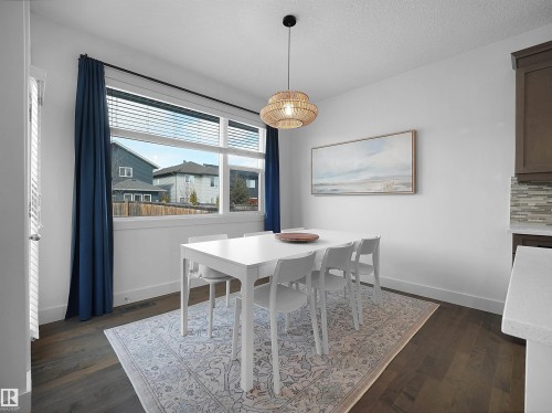 Dining area with dark wood-style floors and a textured ceiling - 3387 Parker Loop, Edmonton, AB - Indoor Photo Showing Dining Room