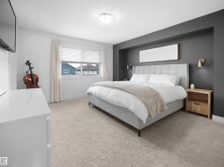 Bedroom featuring light carpet and a textured ceiling - 