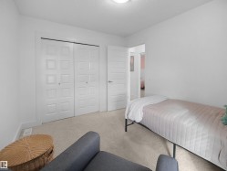 Carpeted bedroom featuring a textured ceiling and a closet - 