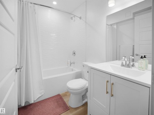 Full bathroom with vanity, shower / tub combo with curtain, and light wood-style floors - 3387 Parker Loop, Edmonton, AB - Indoor Photo Showing Bathroom