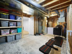 Unfinished basement featuring a water pressure tank - 