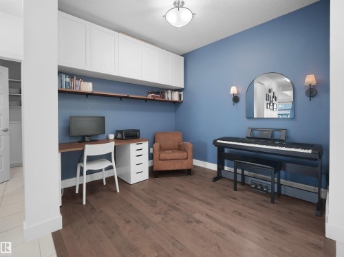 Office space featuring dark wood-style flooring and built in desk - 3387 Parker Loop, Edmonton, AB - Indoor