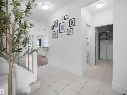 Hallway featuring light tile patterned floors and baseboards - 3387 Parker Loop, Edmonton, AB - Indoor Photo Showing Other Room