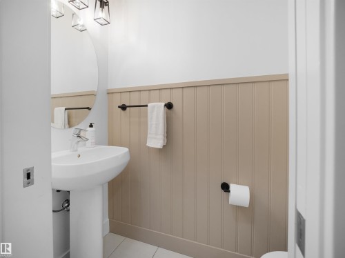 Half bath with wainscoting and toilet - 3387 Parker Loop, Edmonton, AB - Indoor Photo Showing Bathroom