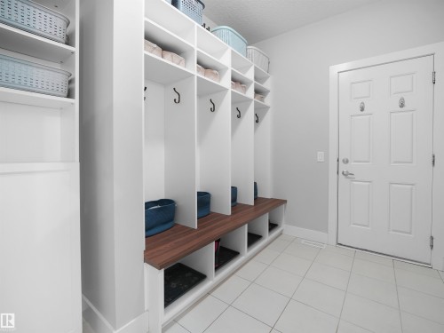 Mudroom with baseboards and light tile patterned floors - 3387 Parker Loop, Edmonton, AB - Indoor