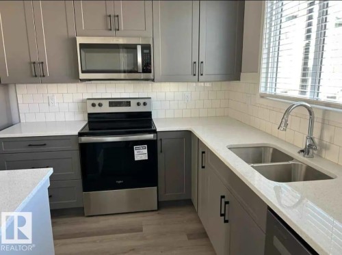 54 320 Secord Boulevard, Edmonton, AB - Indoor Photo Showing Kitchen With Double Sink