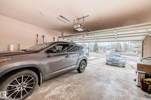The property includes a spacious two-car garage with an automatic garage door opener and a concrete floor - 11532 9 Avenue, Edmonton, AB - Indoor Photo Showing Garage
