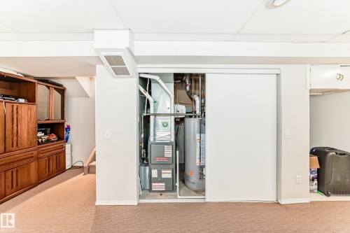 This property includes a utility closet with a water heater and furnace, offering practical functionality - 11532 9 Avenue, Edmonton, AB - 