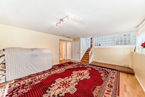 This room features light-colored walls, light wood flooring, and a glass block window - 11532 9 Avenue, Edmonton, AB - Indoor Photo Showing Other Room