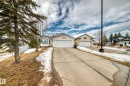 The property features a concrete driveway leading to a two-car garage - 11532 9 Avenue, Edmonton, AB  - Outdoor With Facade 