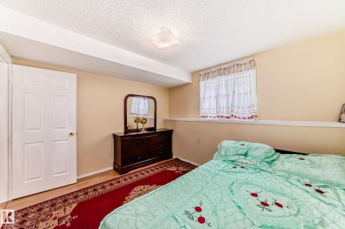 Bedroom featuring light-colored walls and a window with sheer curtains - 11532 9 Avenue, Edmonton, AB - Indoor Photo Showing Bedroom