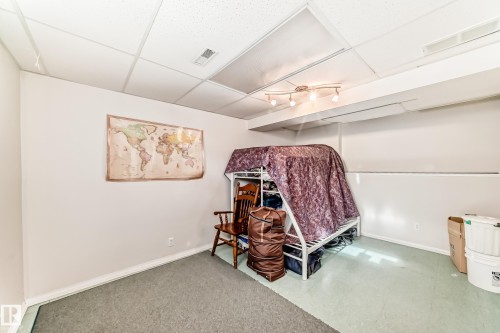 Room featuring a drop ceiling, track lighting, and a neutral color palette on the walls - 11532 9 Avenue, Edmonton, AB - Indoor