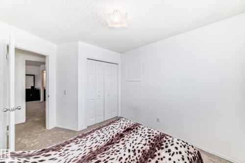 This room features white walls, light-colored carpeting, and a white bi-fold closet - 11532 9 Avenue, Edmonton, AB - Indoor Photo Showing Bedroom