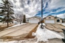 The property features a concrete driveway and an attached garage with a white garage door - 11532 9 Avenue, Edmonton, AB  - Outdoor With Facade 
