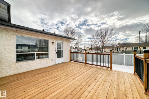 Property features an expansive wooden deck with black and wood railings, ideal for outdoor enjoyment - 11532 9 Avenue, Edmonton, AB - Outdoor With Deck Patio Veranda With Exterior