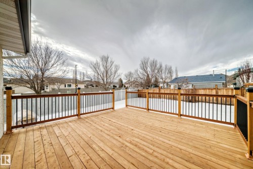 The property includes an expansive wooden deck with black and brown railings - 11532 9 Avenue, Edmonton, AB - Outdoor With Deck Patio Veranda With Exterior