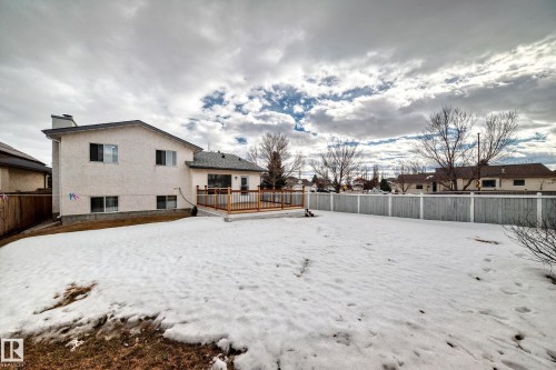 The property features an extensive yard with a wooden deck and privacy fencing - 11532 9 Avenue, Edmonton, AB - Outdoor