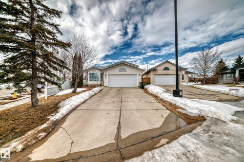 The property features an attached garage with a white garage door and a concrete driveway - 11532 9 Avenue, Edmonton, AB - Outdoor With Facade