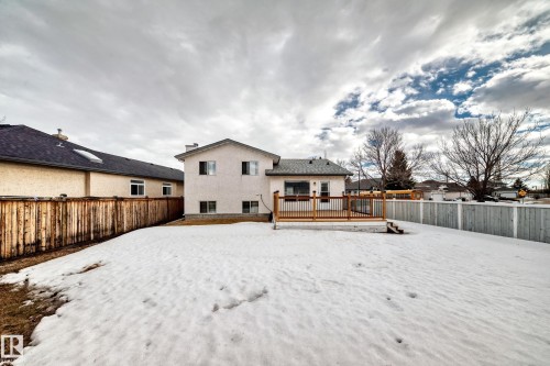 The property features a spacious backyard with a wooden deck and fencing - 11532 9 Avenue, Edmonton, AB - Outdoor With Deck Patio Veranda