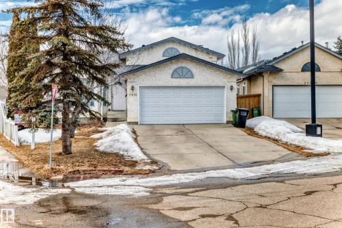 The property features an attached double garage and a paved driveway - 11532 9 Avenue, Edmonton, AB - Outdoor