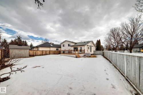 The property features a spacious rear yard with a wooden deck, a wooden privacy fence, and a shed - 11532 9 Avenue, Edmonton, AB - Outdoor