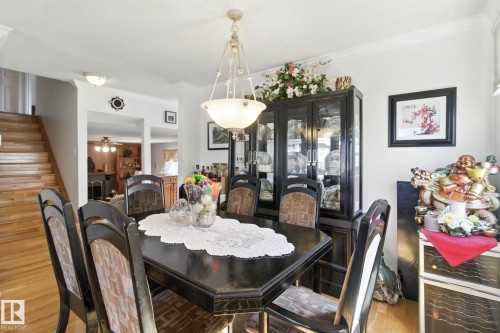 Dining area featuring crown molding, light wood finished floors, and a ceiling fan - 39 Grand Meadow Crescent, Edmonton, AB - Indoor Photo Showing Dining Room