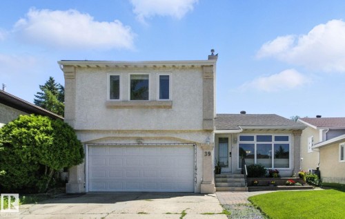 View of front of house featuring an attached garage, stucco siding, and concrete driveway - 39 Grand Meadow Crescent, Edmonton, AB - Outdoor