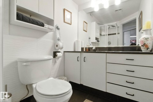 Bathroom with a shower stall, vanity, dark tile patterned floors, and tile walls - 39 Grand Meadow Crescent, Edmonton, AB - Indoor Photo Showing Bathroom