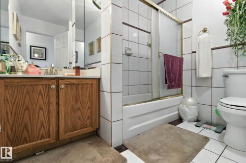 Bathroom featuring vanity, combined bath / shower with glass door, and light tile patterned flooring - 39 Grand Meadow Crescent, Edmonton, AB - Indoor Photo Showing Bathroom