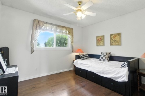Bedroom featuring dark wood finished floors, ceiling fan, and a textured ceiling - 39 Grand Meadow Crescent, Edmonton, AB - Indoor Photo Showing Bedroom