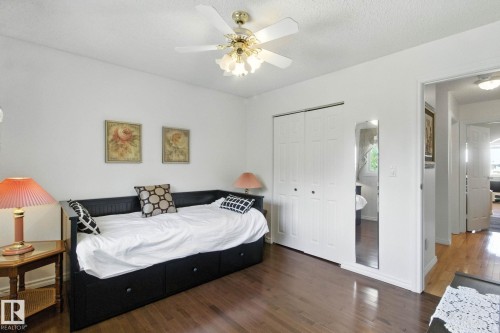 Bedroom featuring dark wood finished floors, a closet, ceiling fan, and a textured ceiling - 39 Grand Meadow Crescent, Edmonton, AB - Indoor Photo Showing Bedroom
