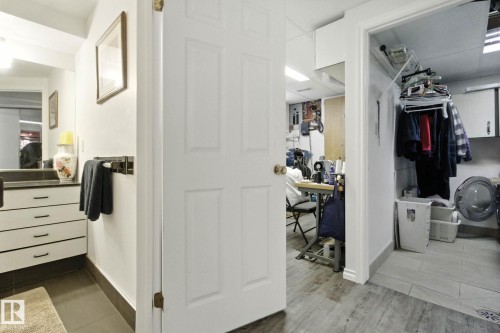 Walk in closet featuring washer / dryer and dark tile patterned floors - 39 Grand Meadow Crescent, Edmonton, AB - Indoor Photo Showing Other Room