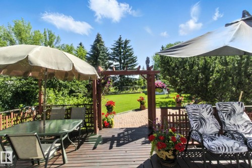 Wooden deck featuring outdoor dining area and a yard - 39 Grand Meadow Crescent, Edmonton, AB - Outdoor With Deck Patio Veranda